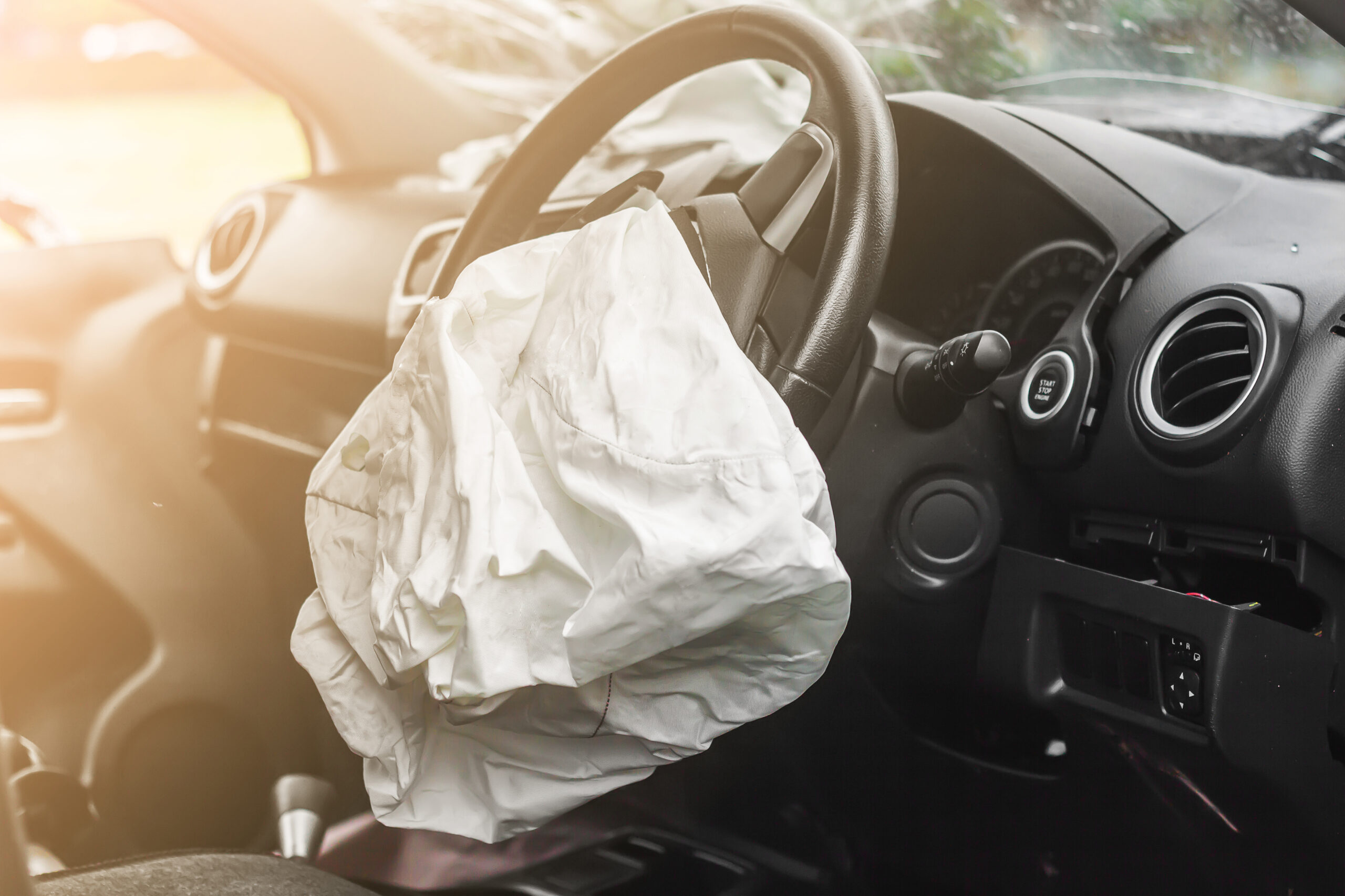 An airbag has exploded inside a car on the drivers' side